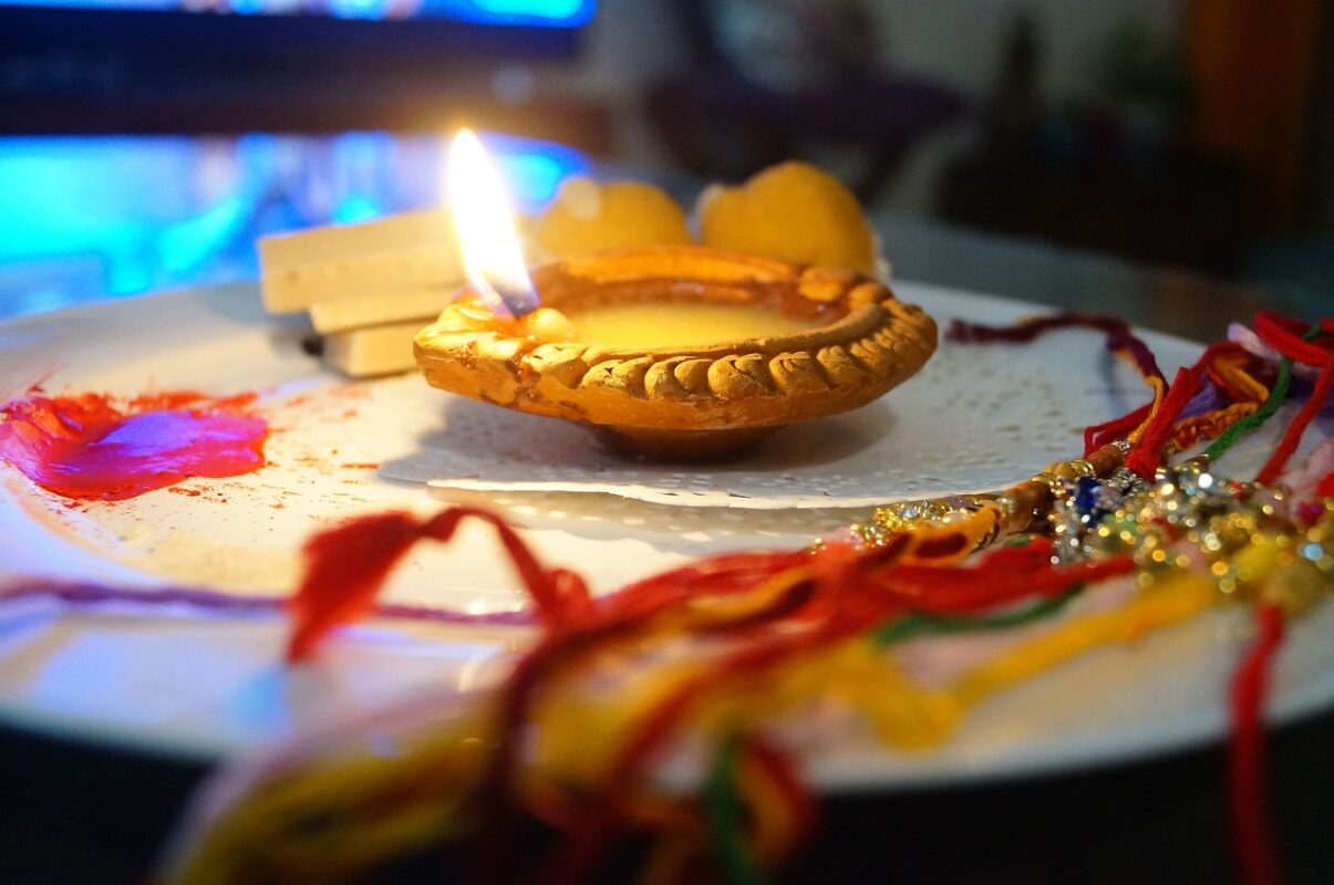 a lit candle on a plate